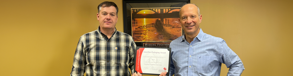 Chris Melino and Mark Janetos holding the 2023 AmeriStar Award